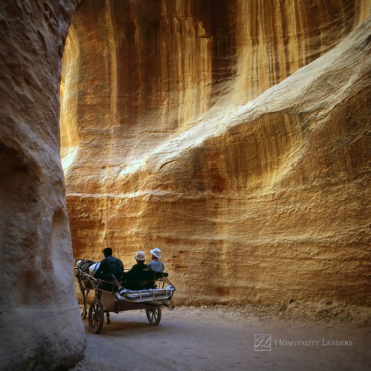 Driving through the Siq in the old city of Petra in Jordan.This city was carved out the rocks. It is now an UNESCO World Heritage site